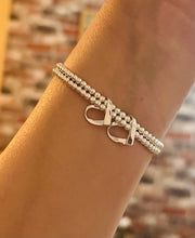 Sterling silver double strand bracelet with 2 ribbon hearts