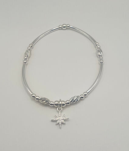 Long spacer with crystal cut oval beads and North Star charm