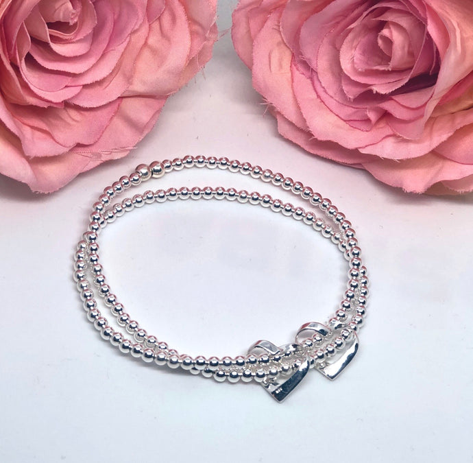 Sterling silver double strand bracelet with 2 ribbon hearts