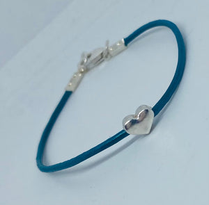 Leather surf bracelet with heart in teal