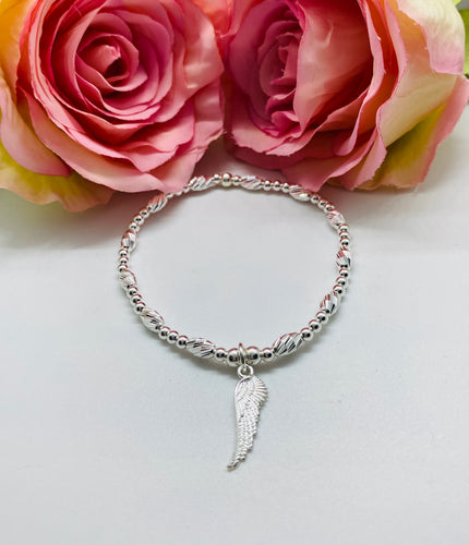 Crystal cut oval spacer bracelet with Angel wing charm