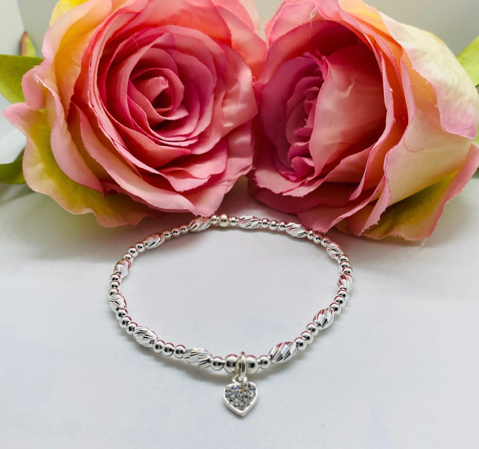Crystal cut oval spacer with crystals heart charm