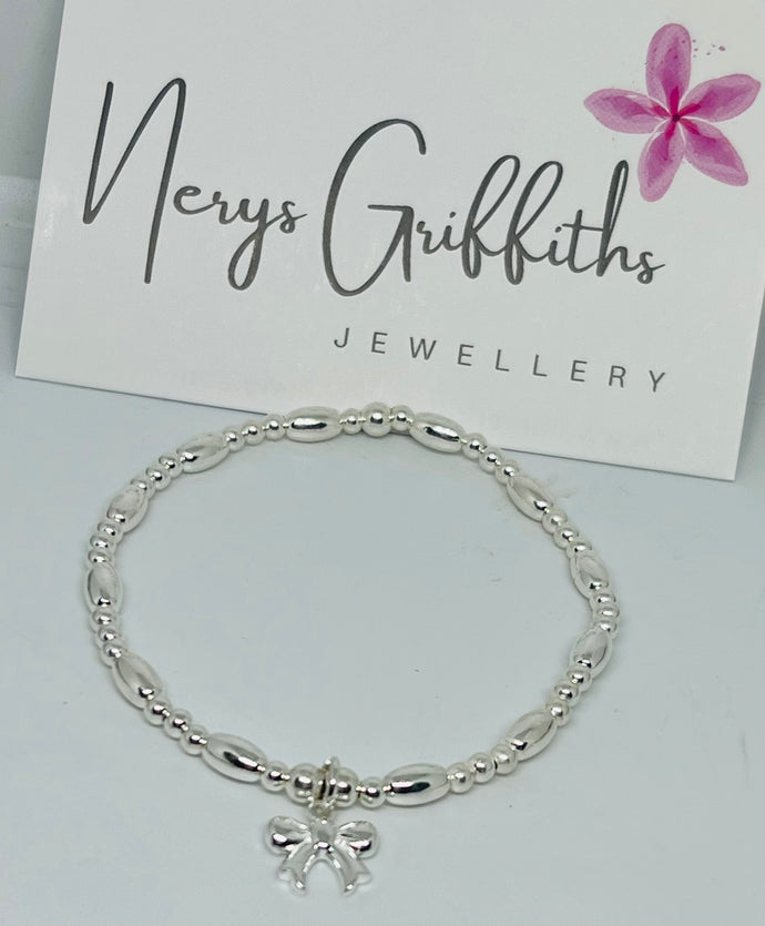 Sterling silver oval spacer bracelet with Bow charm
