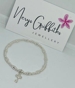 Sterling silver oval spacer bracelet with key charm