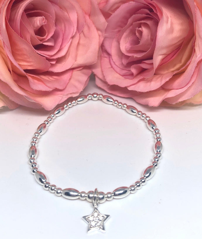 Sterling silver oval spacer with crystal star charm